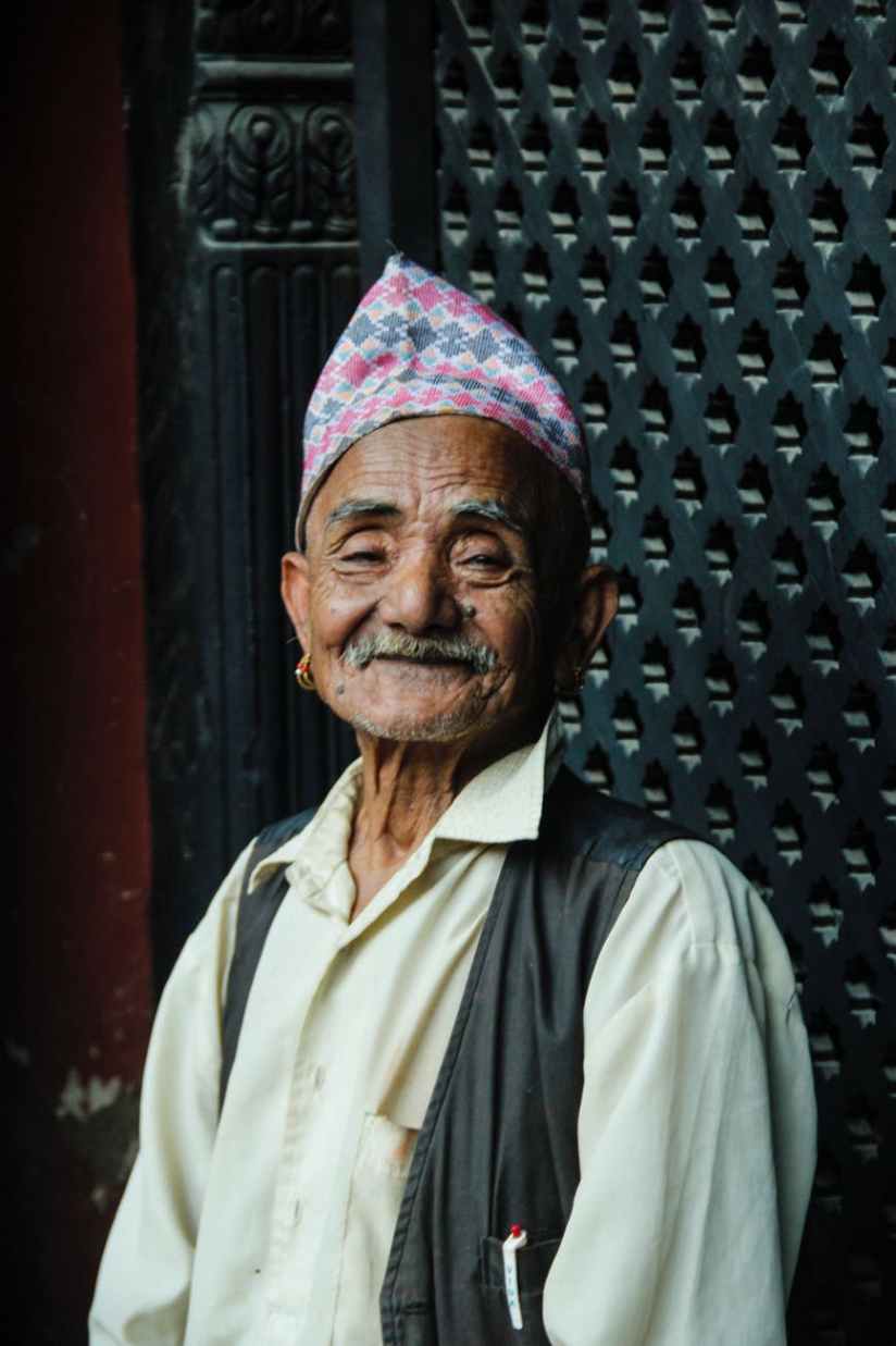 man standing beside black steel frame